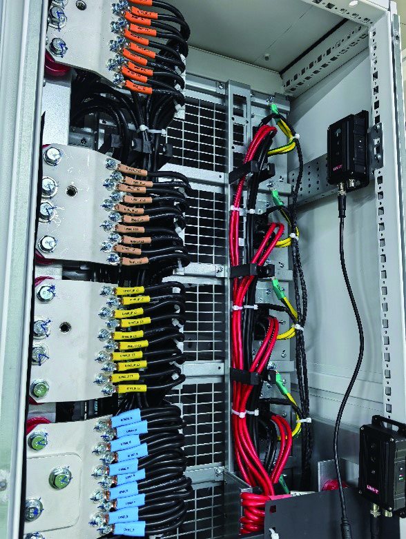 Busbars and cable connections inside a UPS cabinet