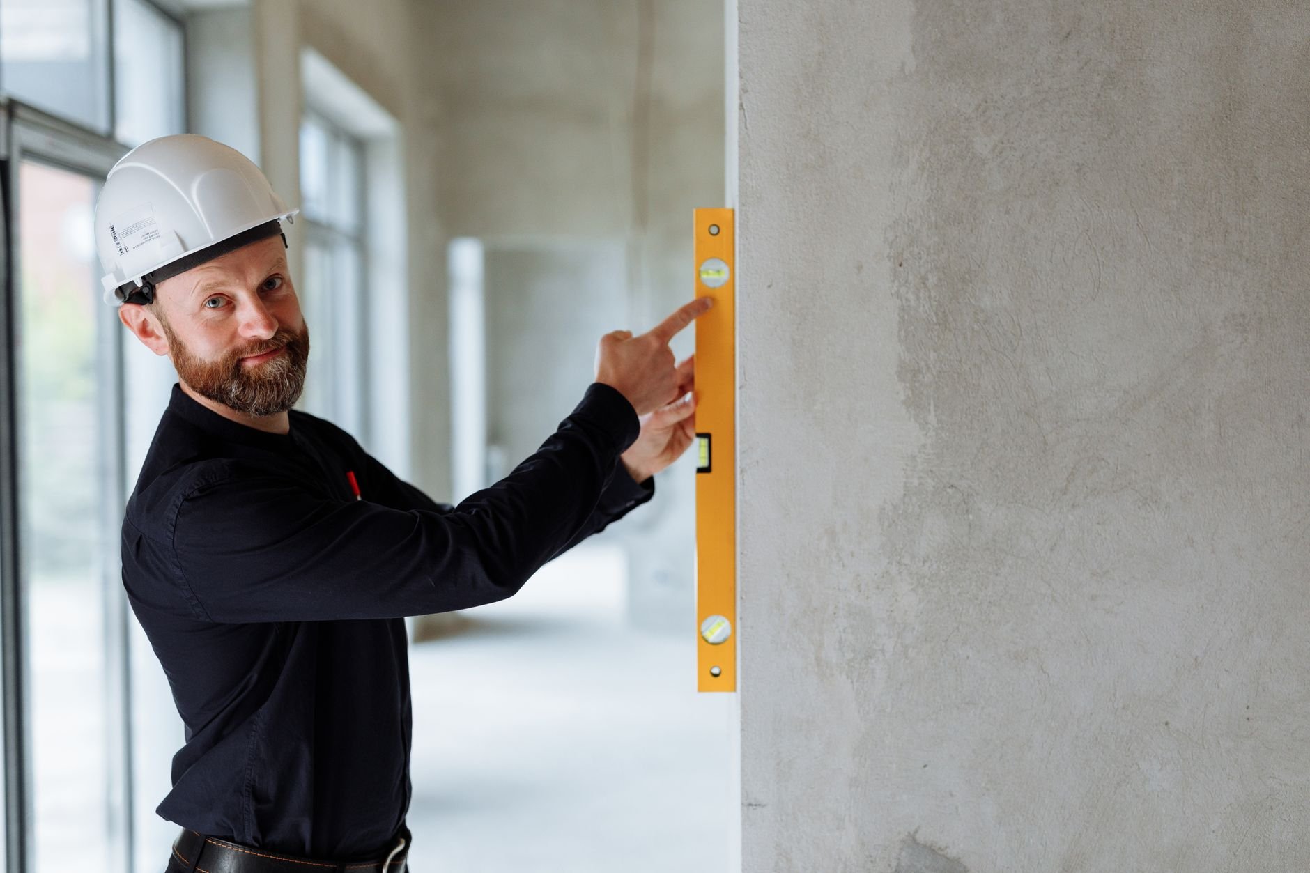 Surveyor with thermal camera inspecting a building interior